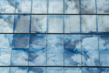 Sky reflected in windows of office building