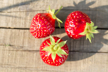 ripe fresh strawberries on wooden background, close up