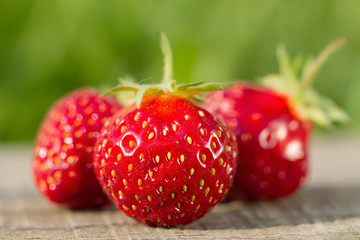 ripe fresh strawberries on wooden background, close up