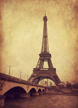 Eiffel tower view from Seine river, Paris, France.  Photo in  grunge and retro style.  Added paper texture
