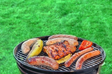 Hot BBQ Grill With Assorted Meat On The Garden Lawn