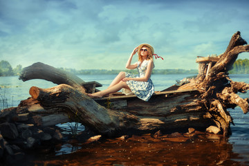 Girl on driftwood