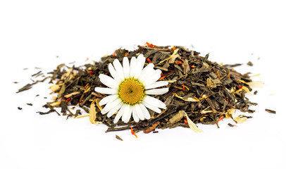 Green dry tea with chamomile flower. On a white background