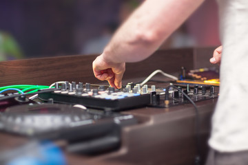 DJ mixing music on console