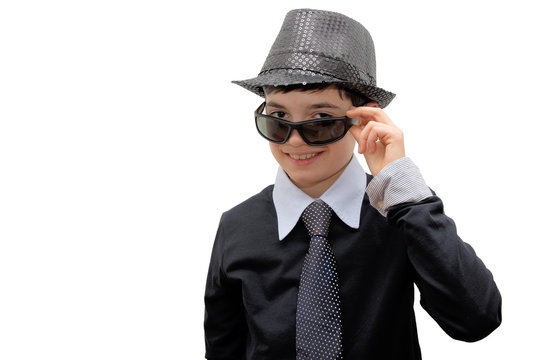 Smiling Boy with carnival costume.Man in black. Teenager in a carnival costume, wearing hat and sunglasses as a detective. Image isolated on white.