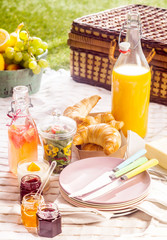 Fruit juice, croissants and fruit for a picnic
