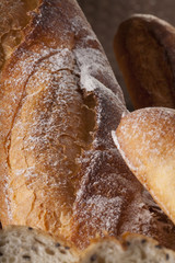 Bread, a set of variation of breads on a wood chopping block with spike