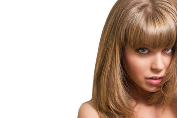 Portrait of a beautiful young blonde woman on a white background