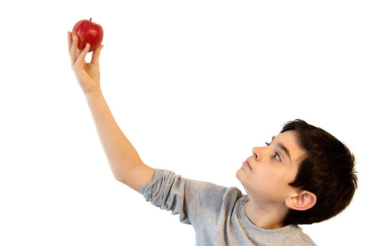 Boy holding an apple.Cute caucasian kid eating an apple. Concept to be not to be. Hamlet, Shakespeare. Isolated on white.