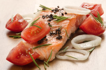 grilled salmon fillet with tomato on wood