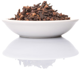 Clove spices in white bowl over white background