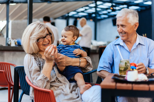 Grandparents With Their Grandson At Cafe