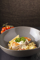 Pasta salmon fresh seasoning pasta with grilled salmon steak in a decor dish