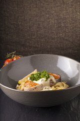 Pasta salmon fresh seasoning pasta with grilled salmon steak in a decor dish