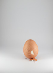 peeled boiled egg on white background.