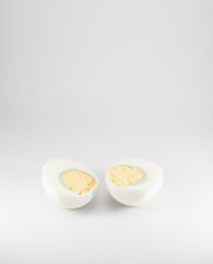 Boiled eggs cut in half on white background. 