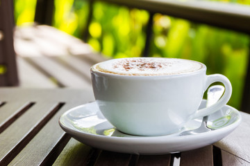 Cappuccino or latte coffee on wooden table.