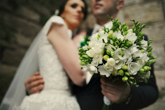 wedding bouquet on background couple