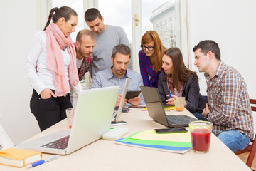 Young group of people discussing business plans.