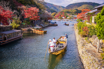 Naklejka premium people sail boates in the river at arashiyama