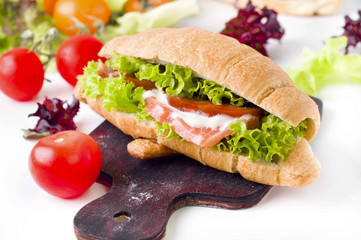 Croissant sandwich with salted salmon on plate,