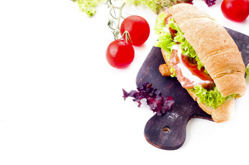 Croissant sandwich with salted salmon on plate,