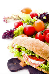Croissant sandwich with salted salmon on plate,