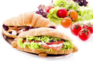 Croissant sandwich with salted salmon on plate,