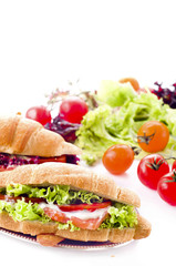 Croissant sandwich with salted salmon on plate,