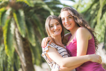 Fototapeta premium Portrait of two beautiful girls at park