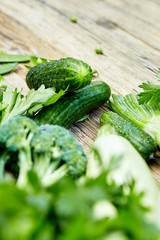 Raw detox green vegetable food set on wood table