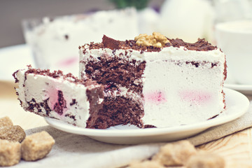 Delicious chocolate cake on plate on table on light background