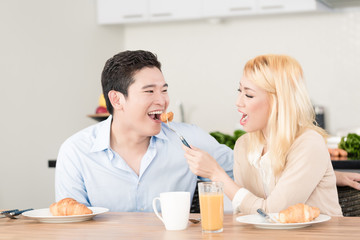 Fototapeta premium Asian couple having breakfast together