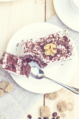 Obraz na płótnie Canvas Delicious chocolate cake on plate on table on light background. Tonned photo.