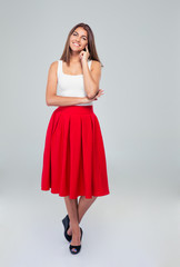 Beautiful happy woman in skirt looking at camera