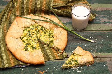 Homemade Pie with green onions and eggs and a glass of milk