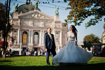 wedding couple on sunset against the backdrop of the opera house