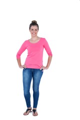 Happy pretty casual brunette looking at camera with hands on hip