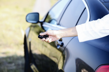 Businesswoman holding car key outdoors