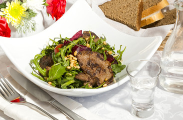 rabbit liver salad with arugula in a restaurant