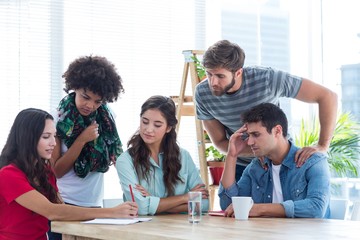 Young colleagues in discussion at office