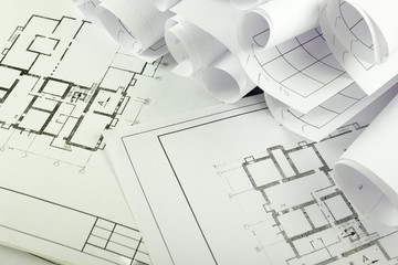 Architectural project, blueprints, blueprint rolls and divider compass, calipers, folding ruler on plans Engineering tools view from the top. Copy space. Construction background.