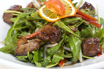 duck with arugula on a white background in the restaurant