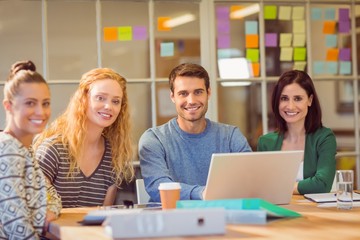 Group of young colleagues using laptop