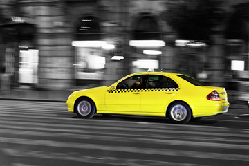 yellow taxi moves on the night city street