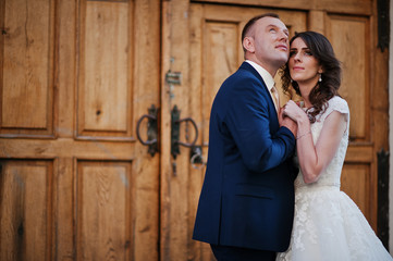 wedding couple on background wooden gates