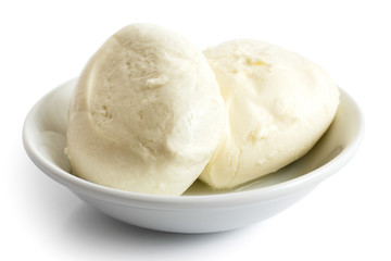 Two balls of mozzarella cheese in a dish, isolated on white.