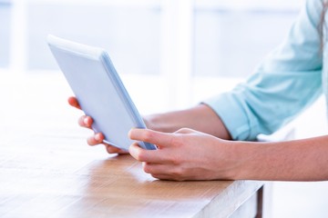 Close up of woman using tablet in meeting