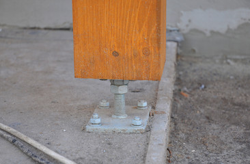 Closeup of wooden pillar on the construction site with screw