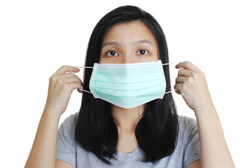 Portrait of Asian woman putting on medical mask on white background.